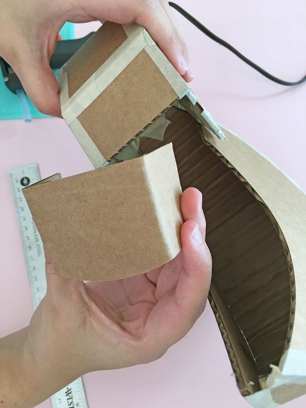 How To Make a Felt Dinosaur Bag Tutorial: Place the neck piece in the back of the head and tape it.