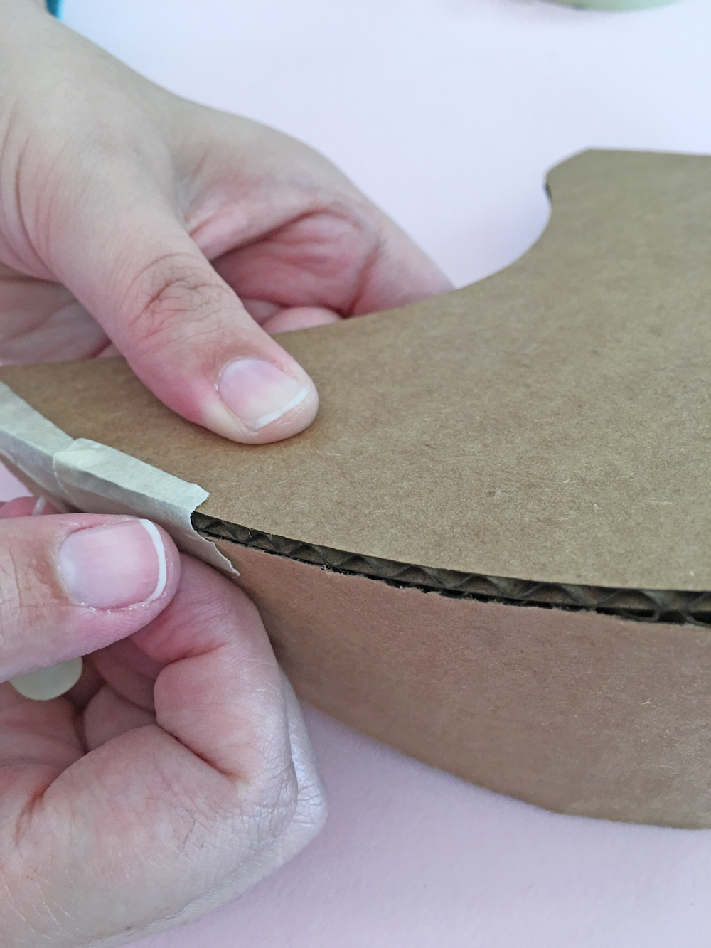 How To Make a Felt Dinosaur Bag Tutorial: Tape the belly piece to the side piece. Make sure to math the two pointy tail sides.