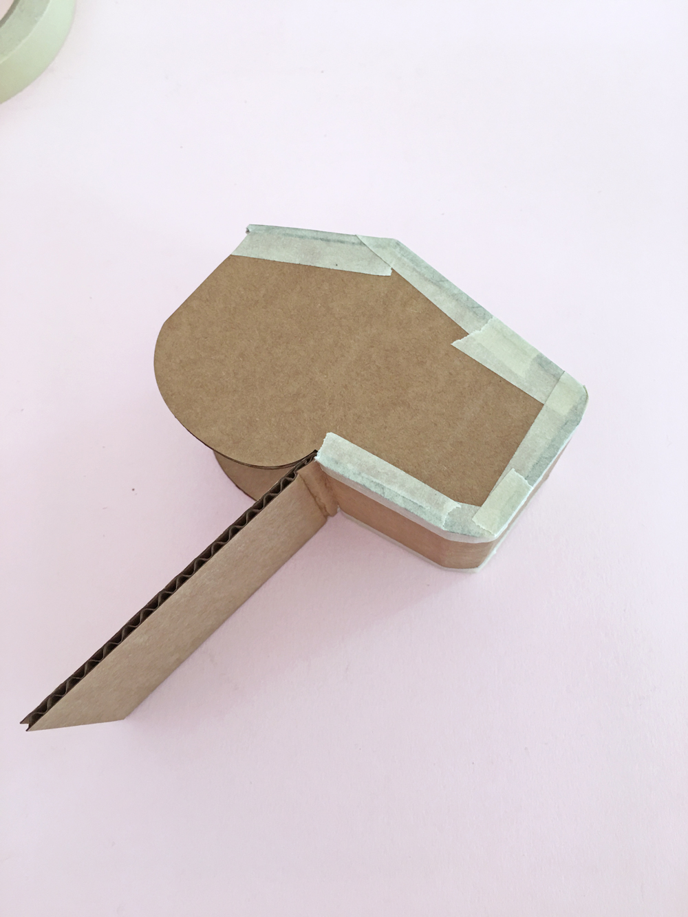 How To Make a Felt Dinosaur Bag Tutorial: Bend the cardboard around the dinosaur face.